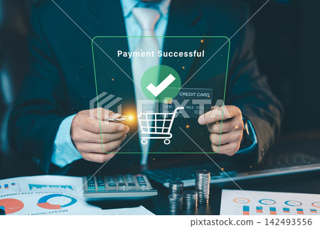 Businessman holding credit card and coins with payment successful hologram interface, mobile banking and online shopping checkout concept. Businessman holding credit card and coins with payment successful hologram interface, mobile banking and online shopping checkout concept. 142493556