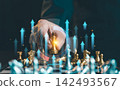 Businessman holding gold king chess piece on chessboard with rising arrow graphic overlay, strategic planning and business growth concept. 142493567