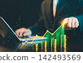 Businessman touching top of rising financial growth chart overlay on gold coin stacks, stock market investment and profit concept. 142493569