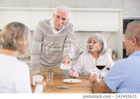 Couples of elderly women and men playing poker Couples of elderly women and men playing poker 142493615