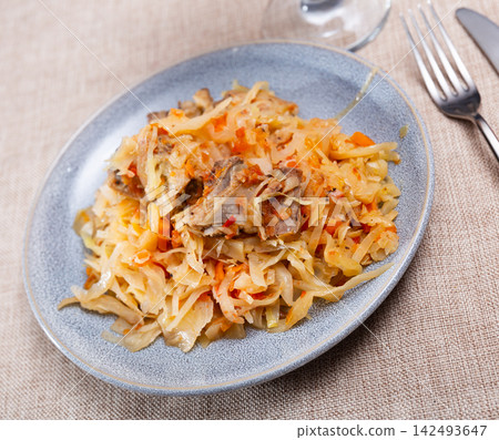 On plate there is stewed cabbage with delicious pork ribs On plate there is stewed cabbage with delicious pork ribs 142493647