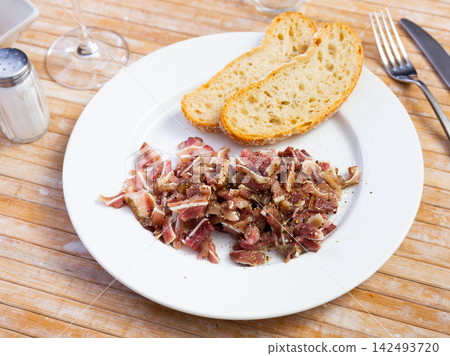 Sliced pig ears served on platter Sliced pig ears served on platter 142493720