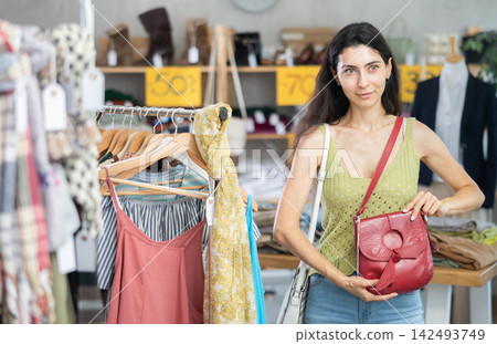 Armenian woman choosing a fashionable handbag Armenian woman choosing a fashionable handbag 142493749