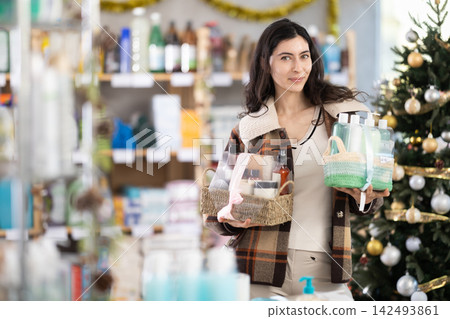 Woman choosing a gift set for the new year Woman choosing a gift set for the new year 142493861