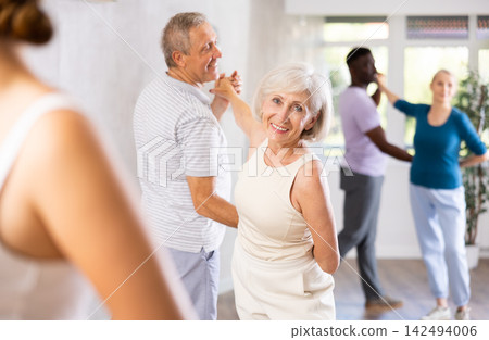 Group of multiethnic mature people dancing social dance 142494006