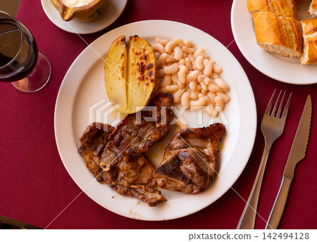 Appetizing lamb stew with boiled potatoes and white beans close up Appetizing lamb stew with boiled potatoes and white beans close up 142494128