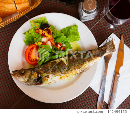 Grilled seabass accompanied by colorful fresh vegetable salad Grilled seabass accompanied by colorful fresh vegetable salad 142494153