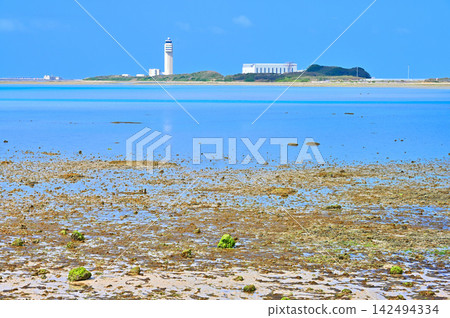 Naha Airport control tower as seen from the beach at Umikaji Terrace on Senaga Island in Tomigusuku City, Okinawa Prefecture. Naha Airport control tower as seen from the beach at Umikaji Terrace on Senaga Island in Tomigusuku City, Okinawa Prefecture. 142494334