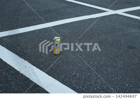 Empty cans left in the parking lot Empty cans left in the parking lot 142494697