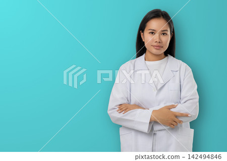 Woman stands with arms crossed in a medical outfit Woman stands with arms crossed in a medical outfit 142494846
