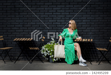 Young beautyful woman with linen eco bag on city background. Young beautyful woman with linen eco bag on city background. 142495209
