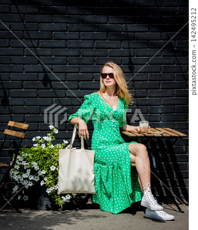 Young beautyful woman with linen eco bag on city background. Young beautyful woman with linen eco bag on city background. 142495212