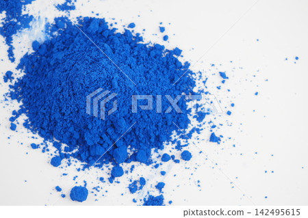 Bright blue powder on white surface Bright blue powder on white surface 142495615