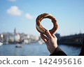 Holding a turkish simits near the water in Istanbul 142495616