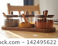 Colorful spice jars on a kitchen table 142495622