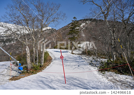 Snow-covered ski resorts in Hakuba, Nagano, with lingering spring snow; snow-covered roads closed off with red "no entry" ropes. [Nagano, Hakuba landscape photo] 142496618