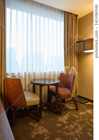 A relaxing space in a hotel room overlooking the city. A relaxing space in a hotel room overlooking the city. 142496946