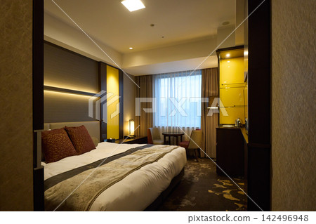 Modern hotel rooms with king-size beds and city views. Modern hotel rooms with king-size beds and city views. 142496948
