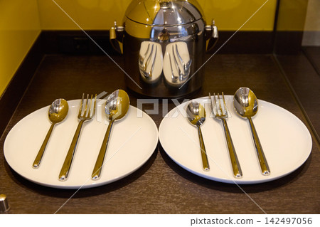 Tableware and cutlery provided in a luxury hotel room Tableware and cutlery provided in a luxury hotel room 142497056