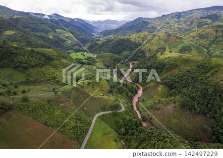 Landscape of Morning Mist with Mountain Layer. mountain ridge and clouds in rural jungle bush forest Landscape of Morning Mist with Mountain Layer. mountain ridge and clouds in rural jungle bush forest 142497229