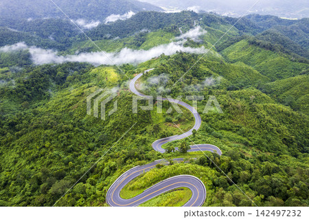 Landscape of Morning Mist with Mountain Layer. mountain ridge and clouds in rural jungle bush forest Landscape of Morning Mist with Mountain Layer. mountain ridge and clouds in rural jungle bush forest 142497232