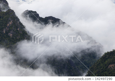 Landscape of Morning Mist with Mountain Layer. mountain ridge and clouds in rural jungle bush forest Landscape of Morning Mist with Mountain Layer. mountain ridge and clouds in rural jungle bush forest 142497290