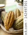 Cacao Tree (Theobroma cacao). Organic cocoa fruit pods in nature. 142497301