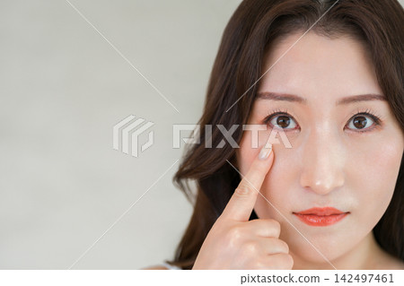 Close-up of the eyes of adult women who are conscious of eye beauty and eye health. Close-up of the eyes of adult women who are conscious of eye beauty and eye health. 142497461