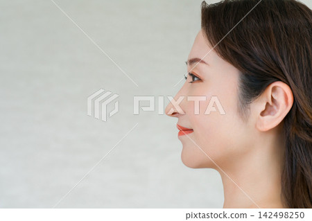 一位成熟女性（40-50歲）的美麗照片，擁有令人印象深刻的下顎線條和側臉輪廓。 142498250