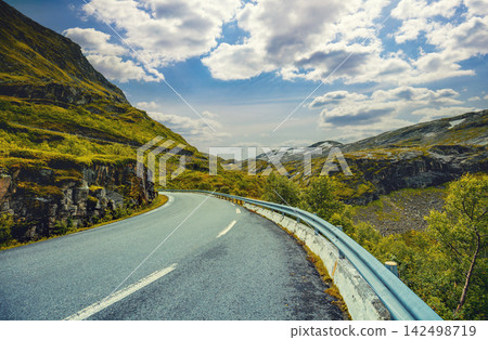 Driving a car on a mountain road. Road among mountains. Road 63 to Geiranger. The beautiful nature of Norway Driving a car on a mountain road. Road among mountains. Road 63 to Geiranger. The beautiful nature of Norway 142498719