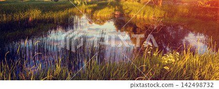 Magical sunrise over the lake. Misty morning, rural landscape, wilderness, mystical feeling Magical sunrise over the lake. Misty morning, rural landscape, wilderness, mystical feeling 142498732