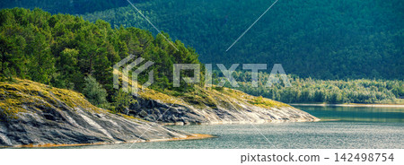 View of the fjord. Rocky seashore. Beautiful nature of Norway View of the fjord. Rocky seashore. Beautiful nature of Norway 142498754