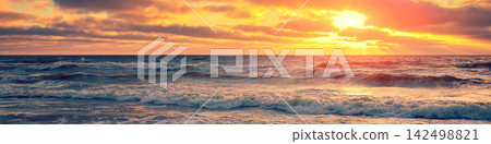 Sea shore at sunset with cloudy sky Sea shore at sunset with cloudy sky 142498821