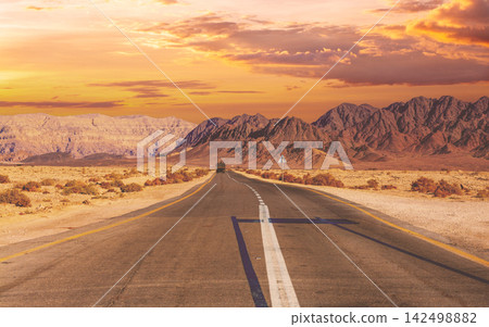 Driving a car on the mountain road in Israel. Desert landscape. Empty road. View from the car of mountain landscape on a sunny day with a clear blue sky. Israel Driving a car on the mountain road in Israel. Desert landscape. Empty road. View from the car of mountain landscape on a sunny day with a clear blue sky. Israel 142498882