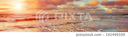 Sunset over sea with oncoming waves Sunset over sea with oncoming waves 142499109