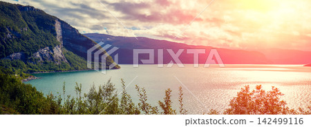 View at fjord at sunset light. Scandinavian landscape. Nature of Norway View at fjord at sunset light. Scandinavian landscape. Nature of Norway 142499116