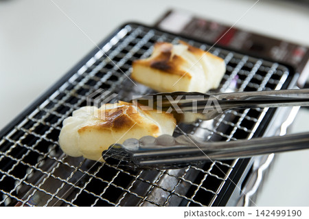Grilled mochi rice cakes on a tabletop stove Grilled mochi rice cakes on a tabletop stove 142499190