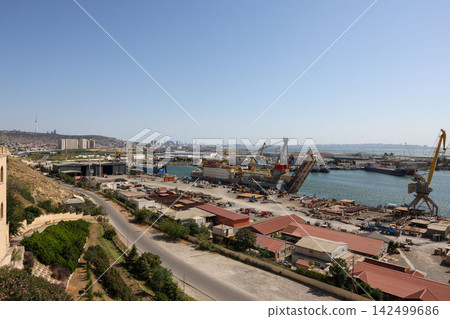 A view of the shipyards and the city of Baku in the background from the Bibi-Heybat Mosque in Azerbaijan. A view of the shipyards and the city of Baku in the background from the Bibi-Heybat Mosque in Azerbaijan. 142499686