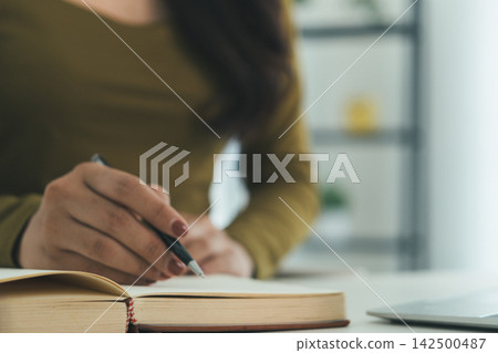 Young Asian Woman Studying Online with Laptop, Tablet, Smartphone and Headphones at Home, Adult Education and E-Learning Young Asian Woman Studying Online with Laptop, Tablet, Smartphone and Headphones at Home, Adult Education and E-Learning 142500487