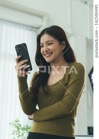 Young Asian Woman Studying Online with Laptop, Tablet, Smartphone and Headphones at Home, Adult Education and E-Learning Young Asian Woman Studying Online with Laptop, Tablet, Smartphone and Headphones at Home, Adult Education and E-Learning 142500495
