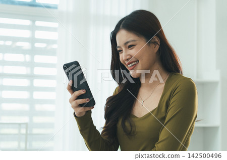 Young Asian Woman Studying Online with Laptop, Tablet, Smartphone and Headphones at Home, Adult Education and E-Learning Young Asian Woman Studying Online with Laptop, Tablet, Smartphone and Headphones at Home, Adult Education and E-Learning 142500496