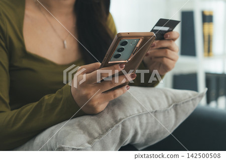 Young Asian Woman Studying Online with Laptop, Tablet, Smartphone and Headphones at Home, Adult Education and E-Learning Young Asian Woman Studying Online with Laptop, Tablet, Smartphone and Headphones at Home, Adult Education and E-Learning 142500508