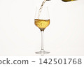 White wine pouring from green bottle on white isolated, close up. 142501768