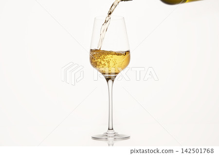 White wine pouring from green bottle on white isolated, close up. 142501768