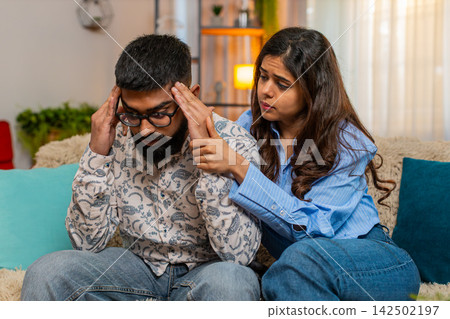 Indian couple man woman sharing emotional hug at home, supporting comforting during difficult moment Indian couple man woman sharing emotional hug at home, supporting comforting during difficult moment 142502197