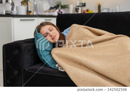 Young woman collapses on pillow after long work shift stressed and tired eyes close and falls asleep 142502506