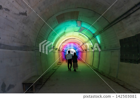 Person walking in tunnel Person walking in tunnel 142503081