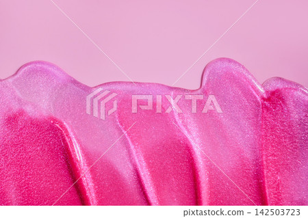 Pink glitter makeup product forming an abstract wave pattern with copy space Pink glitter makeup product forming an abstract wave pattern with copy space 142503723