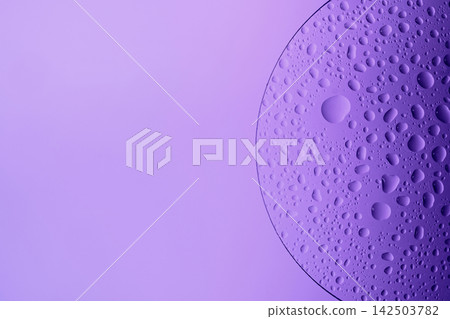 Water drops on glass slide, forming an abstract purple pattern Water drops on glass slide, forming an abstract purple pattern 142503782