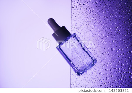 Dropper bottle hydrating purple background with fresh water drops Dropper bottle hydrating purple background with fresh water drops 142503821